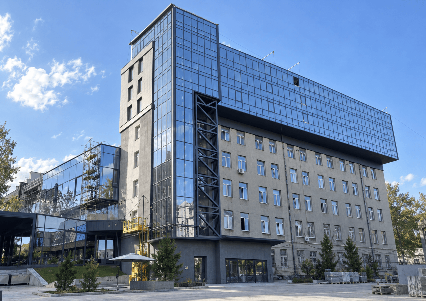 Modern multistory building with a glass curtain-wall facade under construction
